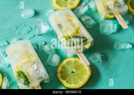 Lemon and mint detox ice cream popsicles on turquoise background Stock Photo