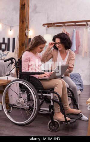 Focused handicapped girl using laptop Stock Photo