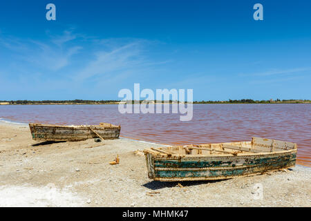 Two boats for sailing on the coast of the pink lake in Africa Stock Photo