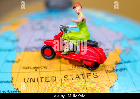 Travel Concept. Woman miniature figure ride motorcycle Stock Photo