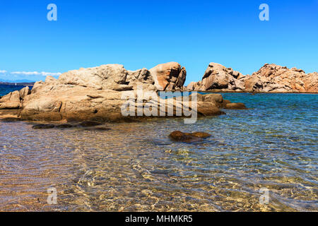 a view of the clear water of the Mediterranean sea and a group of rock formations in a quiet beach in the coast of Baja Sardinia, in the famous Costa  Stock Photo