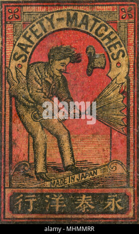 Old Japanese Matchbox label with man with an umbrella Stock Photo