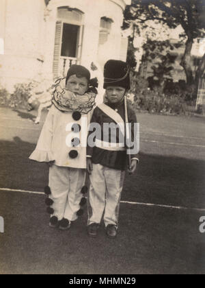 Children in clown and soldier fancy dress Stock Photo