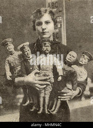 An female worker posed with war dolls representing the King, Lord Kitchener, Sir John French, Sir John Jellicoe and General Joffre.  A selection of British-made toys during the First World War.  Before the war, Germany had been the premier supplier of toys to Britain, but British industry quickly adapted, employing many women in the process.       Date: 1915 Stock Photo