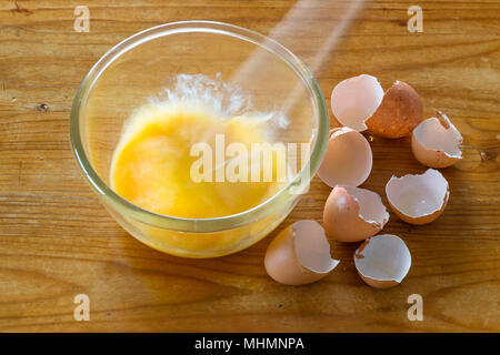 Beating eggs in bowl for scrambling and omelettes Stock Photo