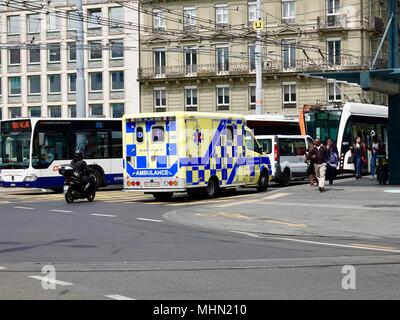 Tram, bus, motorcycle, ambulance, traffic passing through a transportation hub in heavy traffic, Geneva, Switzerland. Stock Photo