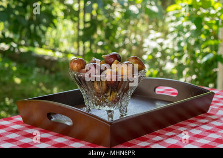 Fresh ripe organic figs in a glass bowl on table Stock Photo