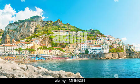 panoramic view of Amalfi beach and houses from stone pier on sunny summer day, Salerno, Campania, Italy Stock Photo