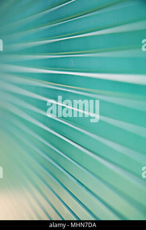 Macro shot of a stack of green glass panels with converging lines and shallow depth of field. Stock Photo