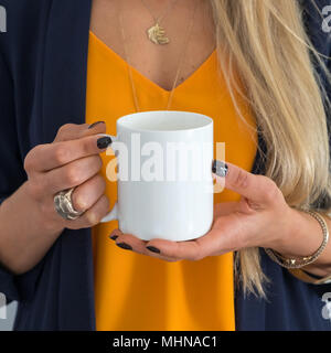 womans hands holding a white mug, perfect for displaying your quote, design on mugs you sell. Stock Photo