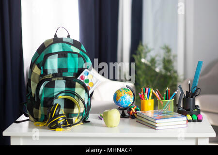 The school backpack is on the table. School supplies Stock Photo