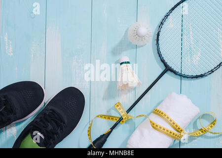 Top view of sport equipments, clock, tape measure, shoes, water bottle, towel, badminton racket and shuttlecock, Healthy lifestyle and fitness concept Stock Photo