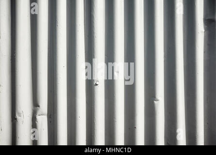 Weathered corrugated white painted metal sheet background. Stock Photo