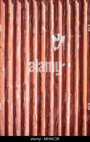 Weathered corrugated red rusty metal sheet, abstract background. Stock Photo