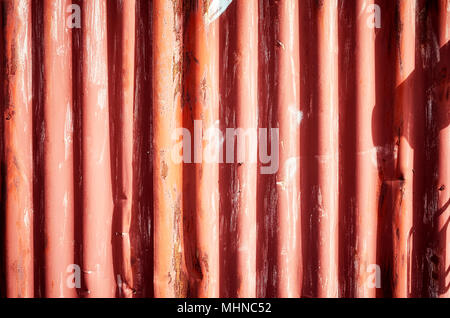 Weathered corrugated red rusty metal sheet, abstract background. Stock Photo