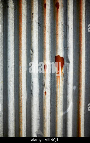 Weathered corrugated rusty metal wall, abstract background. Stock Photo