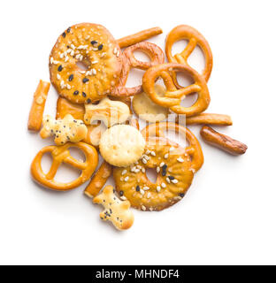 Mixed salty snack crackers and pretzels isolated on white background. Stock Photo