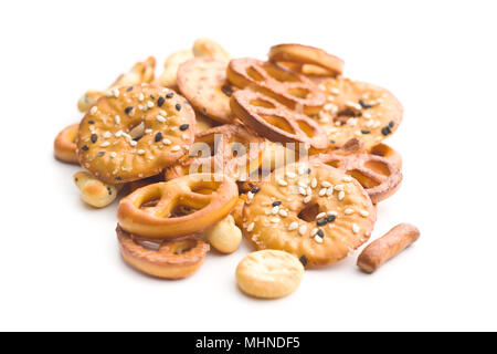 Mixed salty snack crackers and pretzels isolated on white background. Stock Photo