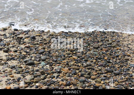 Waves Crashing Over Pebbles. Oceanside, CA Stock Photo