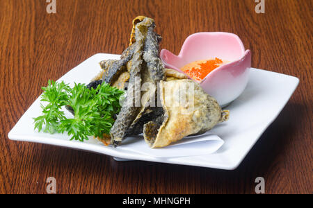 japanese cuisine. fried fish skin on background Stock Photo