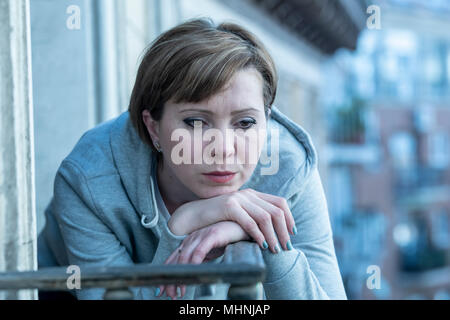 young beautiful unhappy lonely woman suffering from depression staring hopeless and worried on the balcony at home. having feelings of failure, dissat Stock Photo