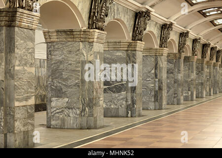 Fragment of the interior with columns lined with gray granite and metal decor Stock Photo