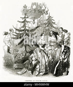 Interesting engraving of Queen Victoria at Winsor Castle in the drawing- room, presenting gifts to her guests in 1846. The room was surrounded by several German Christmas trees nearly eight feet in height, placed in green stands, some frosted to resemble icicles and snow and others were beautifully ornamented with decorations and each tree brilliantly lighted with seventy-two wax candles and suspended with bon-bons, inclosed intastefully ornamented bags and boxes for the presentation as Christmas souvenirs to her Majesty's guests. Two years later 'The Illustrated London News,' in 1848 publishe Stock Photo