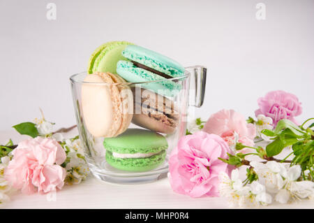 French macaroons in cup. Turquoise, chocolate and green colors. Spring concept. Stock Photo