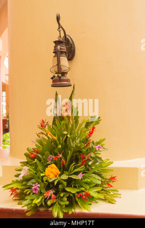 Montage of a bouquet of flowers under an old lantern pose on a wall in the city of Nairobi Kenya Stock Photo