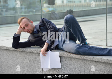 dismissed employee sleeps on the street Stock Photo