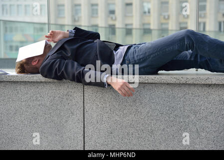 dismissed employee sleeps on the street Stock Photo