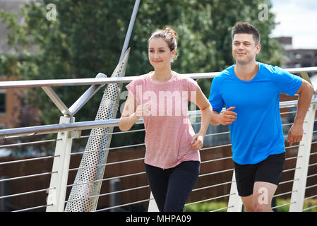Young Couple Exercising In Urban Environment Stock Photo
