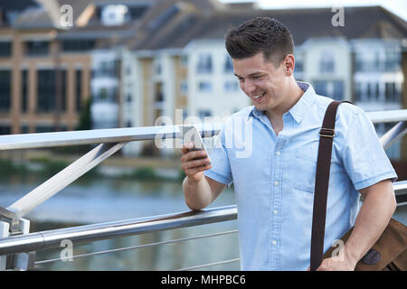 Man Texting On Mobile Phone On Way To Work Stock Photo