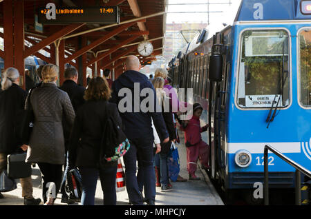 Stockholm, Sweden - May 12, 2014: People walking on the plattform at Stockhol East station servining Roslagsbanan network towards the train with desti Stock Photo