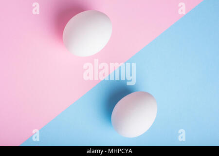 Two eggs on flat lay blue pink background Stock Photo