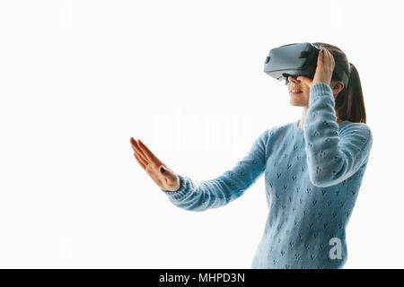 A young beautiful woman in glasses of virtual reality saw something amazing. Modern technologies. Stock Photo