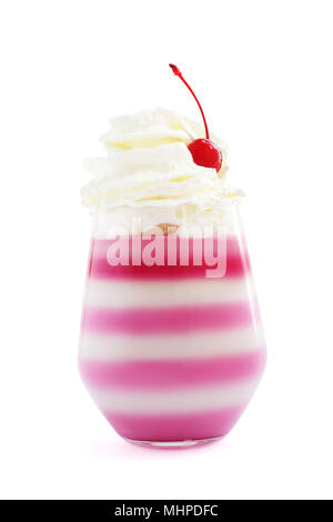 Pink striped jello dessert in glass with whipped cream and red candied cherry on top isolated on white background Stock Photo