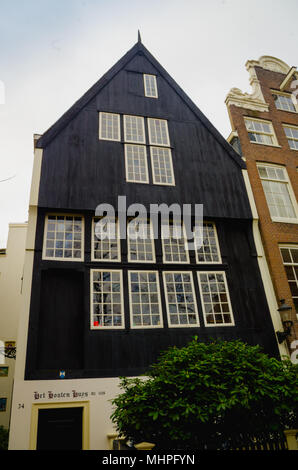 AMSTERDAM, NETHERLANDS, APRIL, 23 2018:Outdoor view of black wooden house in the begijnhof dowtown