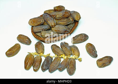 basket of dates and some fruits on their branch Stock Photo