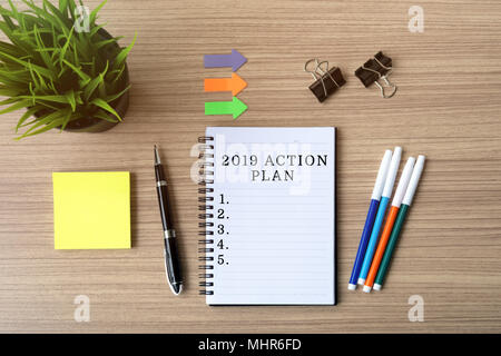 2019 Action Plan on notepad, flat lay business office desk. Stock Photo