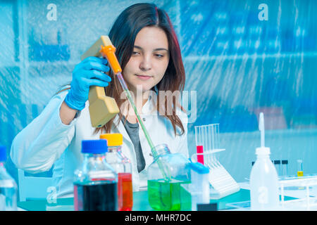 Scientists mixing chemicals. Chemical experiment Stock Photo
