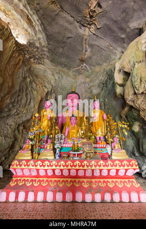 Several Buddha statues on altar inside the Tham Sang (or Xang) Cave, also known as the Elephant Cave, near Vang Vieng, Vientiane Province, Laos. Stock Photo