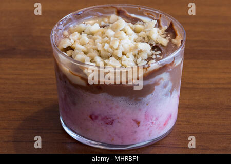 Sweet spoon with strawberry and chocolate cream, dessert in transparent glass. Food photography Stock Photo