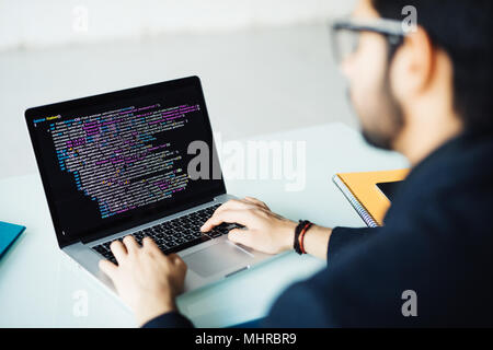 Indian software developer busy with work on new project Stock Photo