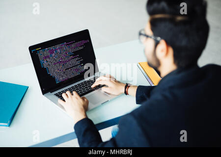 Indian software developer busy with work on new project Stock Photo