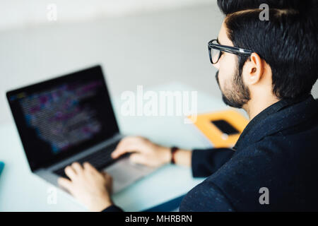 Indian software developer busy with work on new project Stock Photo
