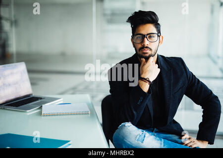 Young dreamy businessman in suit thinking of business vision outlook planning future project idea at work with laptop, successful happy contemplative  Stock Photo