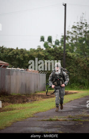 Staff Sgt. Gary G. Olsen-Saville of the 1984th United States Army Hospital Detachment 2 completes the last stretch of the 12-mile ruck march during the Best Warrior Competition at Schofield Barracks, Hawaii Mar. 2, 2018.  The Best Warrior Competition recognizes Soldiers who demonstrate commitment to the Army Values, embody the Warrior Ethos, and represent the Force of the Future. Stock Photo