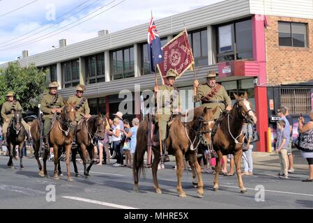 Crowd watch cavalry or horsemen or lancers at ANZAC Day parade in Australian city of Coffs Harbour Stock Photo