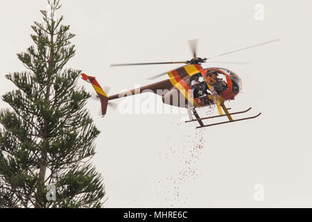 A helicopter drops flower petals onto the ground to celebrate a dedication ceremony at the Hawaii Memorial Park, Kaneohe, Hawaii, Mar. 17, 2018. Multiple organizations including federal, state and local members helped support the construction of a stone memorial honoring the Gold Star Families who have lost loved ones, while serving in the U.S. military. The Gold Star Families Memorial Monument Foundation was created by WWII Medal of Honor recipient Hershel “Woody” Williams in 2010 to remember families who have made the ultimate sacrifice. (U.S. Marine Corps Stock Photo